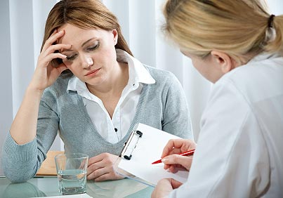 A young woman in a conversation with a consultant or psychologist. (stock image)