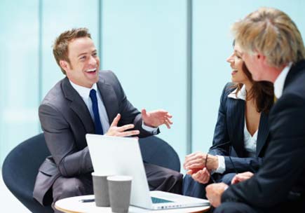 An executive tells an entertaining tale to his colleagues. (stock image)