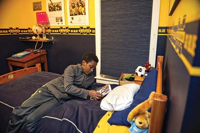 Feleke reads in his bedroom in the Logues' home. (Image: Leisa Thompson.)