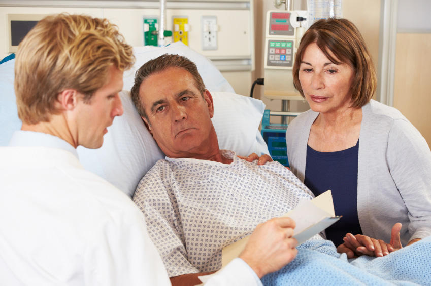 A doctor meets with a couple at the hospital. (stock image)