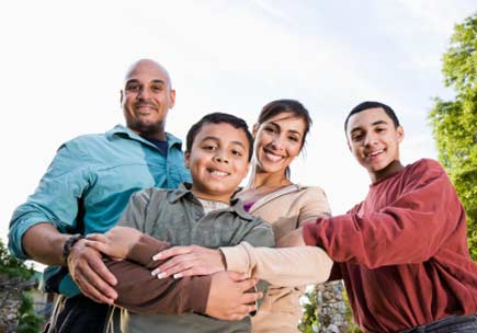 Portrait of Hispanic family outdoors. (stock image)