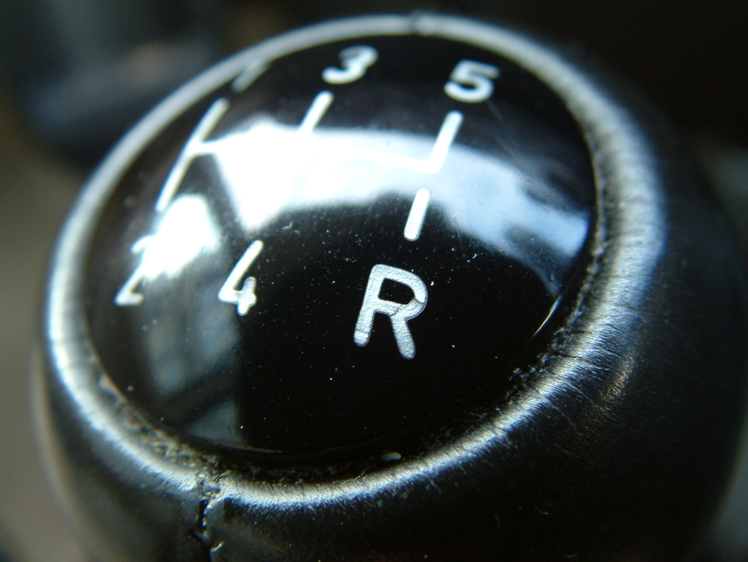 Automobile gear shifter knob with R (Reverse) in focus. Image credit: sxc.hu user myles