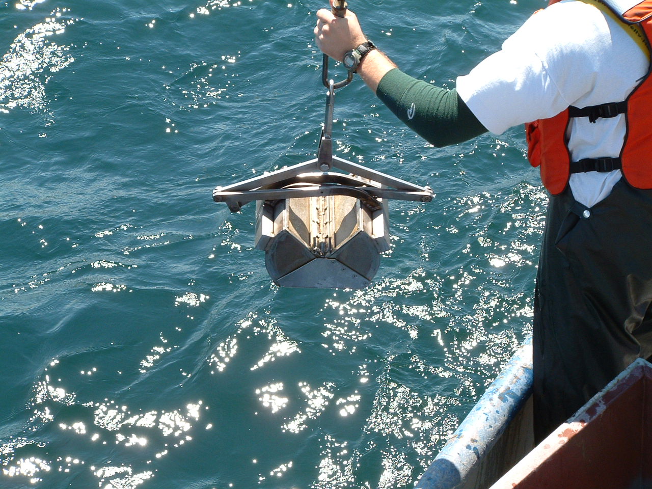 A sampling device called a Ponar Grab is lowered in Lake Erie's Central Basin to collect bottom-dwelling invertebrates. The work was part of a study examining the impacts of low-oxygen hypoxic zones in the lake. Image credit: James Roberts