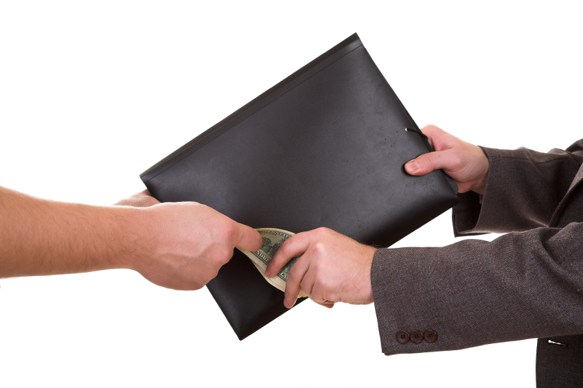 A document portfolio being exchanged for cash. (stock image)