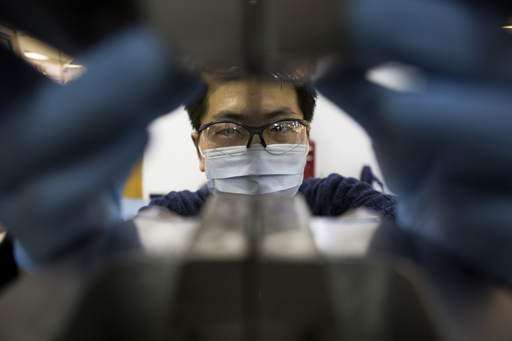 Jeong-Seop Yoon, ME MSE Student, tests the tensile strength of a piece of aluminum alloy in the S.M. Wu Manufacturing Research Center.  Photo: Joseph Xu, Michigan Engineering Communications & Marketing