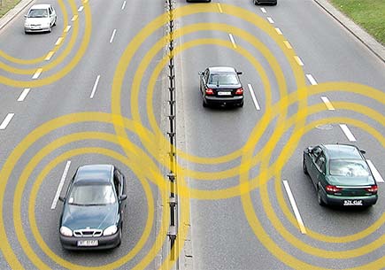 Several cars on a roadway with each emitting communication signals.