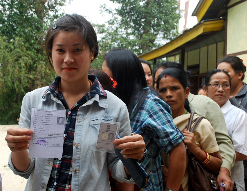 A first time female voter displaying her voter identity card, at a polling booth during the 4th Phase of Lok Sabha General Elections-2014, in Sikkim on April 12, 2014. Image credit: By Press Bureau of India [see page for license], via Wikimedia Commons