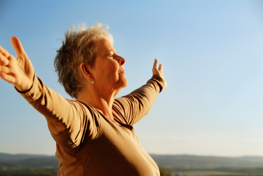 A senior woman embraces the world. (stock image)