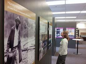 Visitors enjoy Sayles exhibit.
