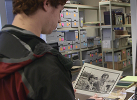 Student peruses the Sayles archives.