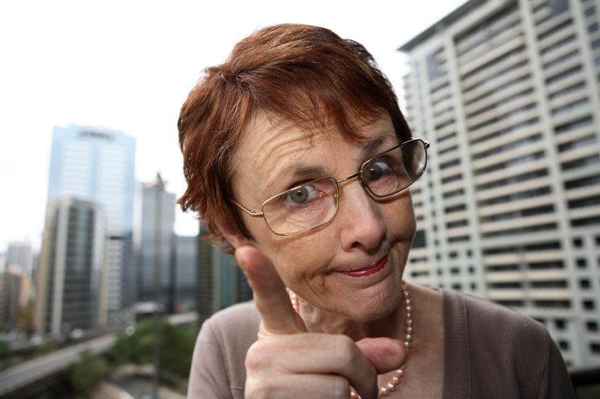 An older woman shakes her finger and advises. (stock image)