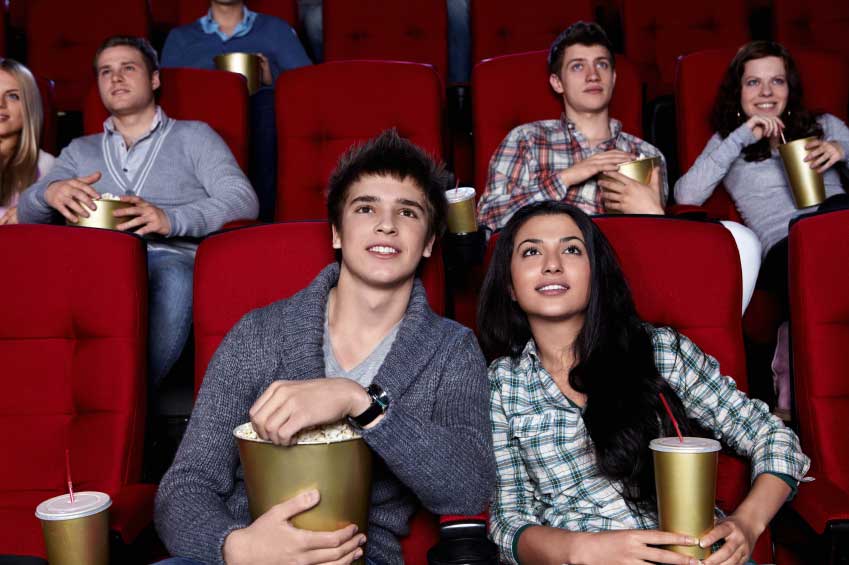 An audience watching a movie in a theater. (stock image)