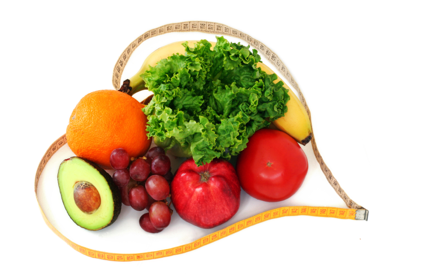  Fresh fruits and vegetables surrounded by a heart shaped measuring tape on white background. (stock image)