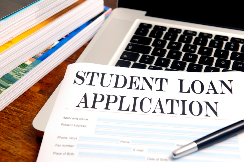  blank student loan application on desk with pen, books and laptop. (stock image)