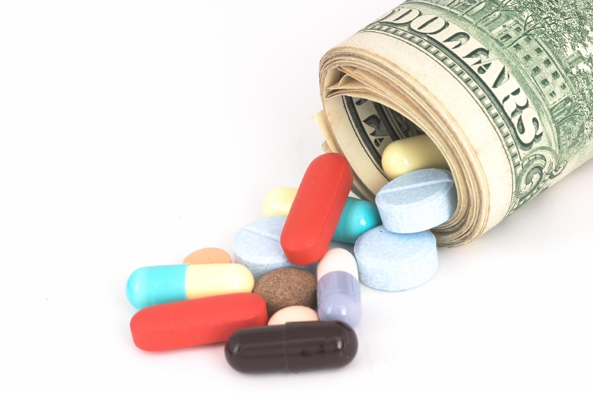  Closeup shot of money rolled up with pills falling out. (stock image)