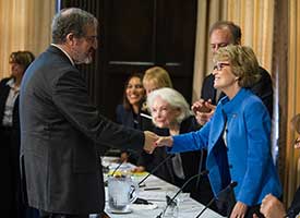 Schlissel and Coleman shake hands