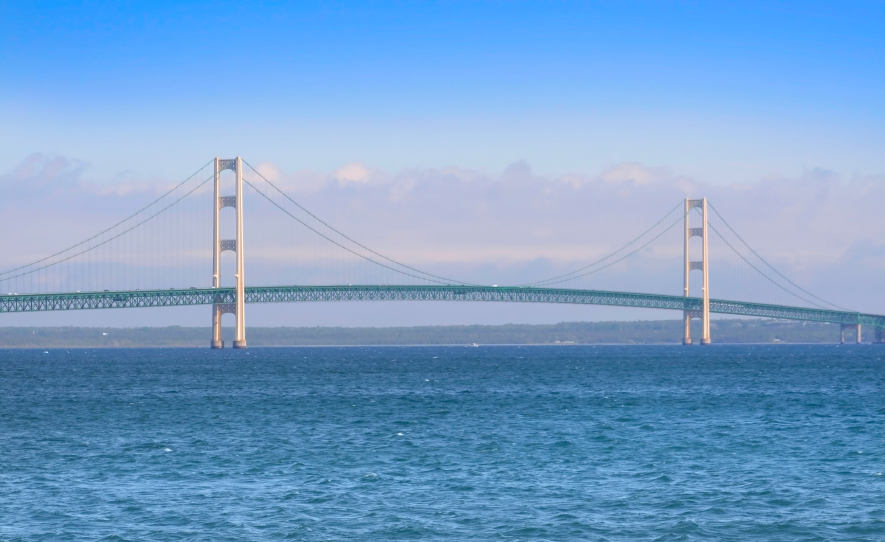 A photo of the Mackinac Island bridge with a cloudy background. (stock image)