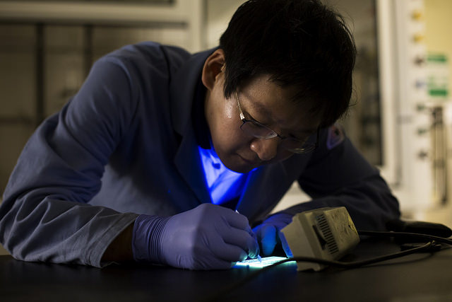 Min Sang Kwon, Postdoctoral Fellow, tests phosphorescent LEDs by writing on them with water in the NCRC in Ann Arbor, MI on July 9, 2014. Image credit: Joseph Xu