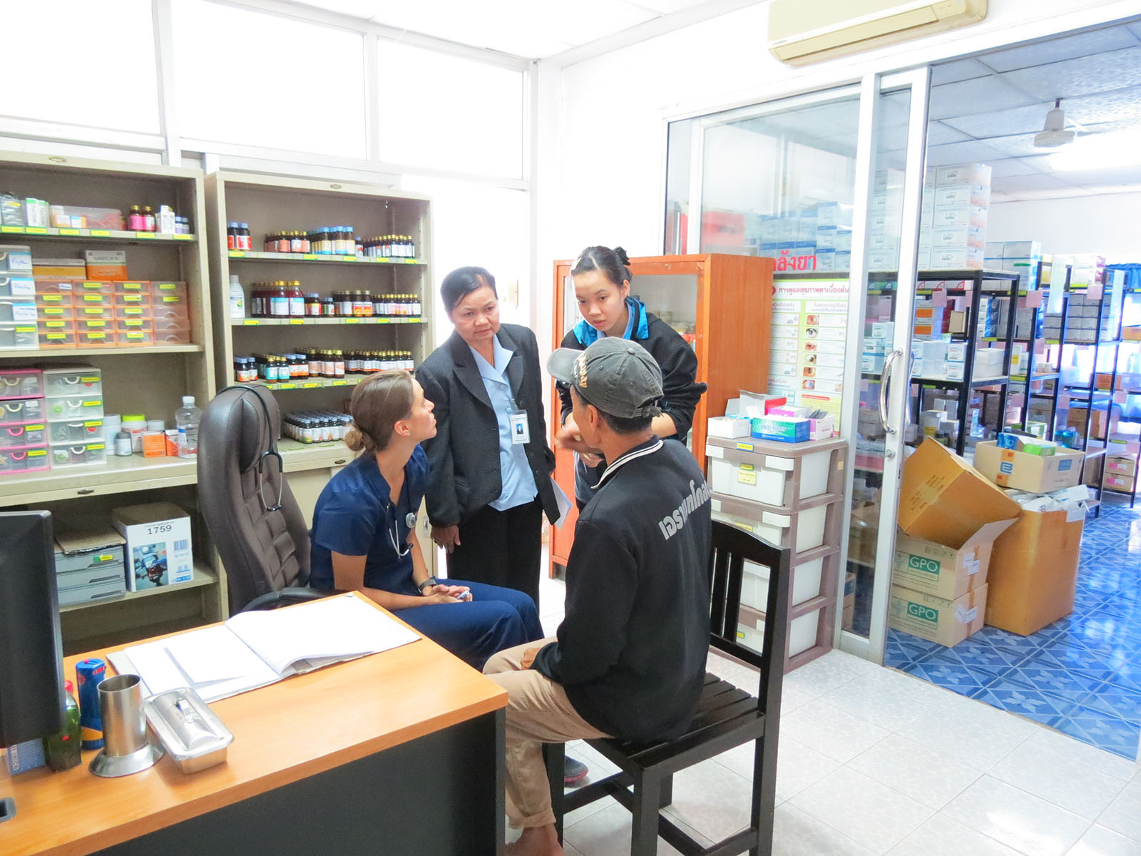 A U-M School of Nursing student cares for a patient in Thailand while a Thai colleague provides translation. U-M has longstanding ties with nursing programs in Thailand. Image credit: U-M School of Nursing