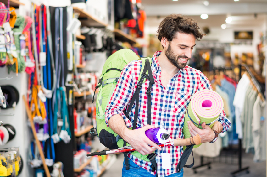  Man in sports goods store buying items for outdoor activities. (stock image)
