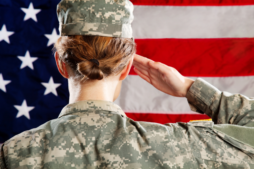 A female soldier solutes the flag. (stock image)