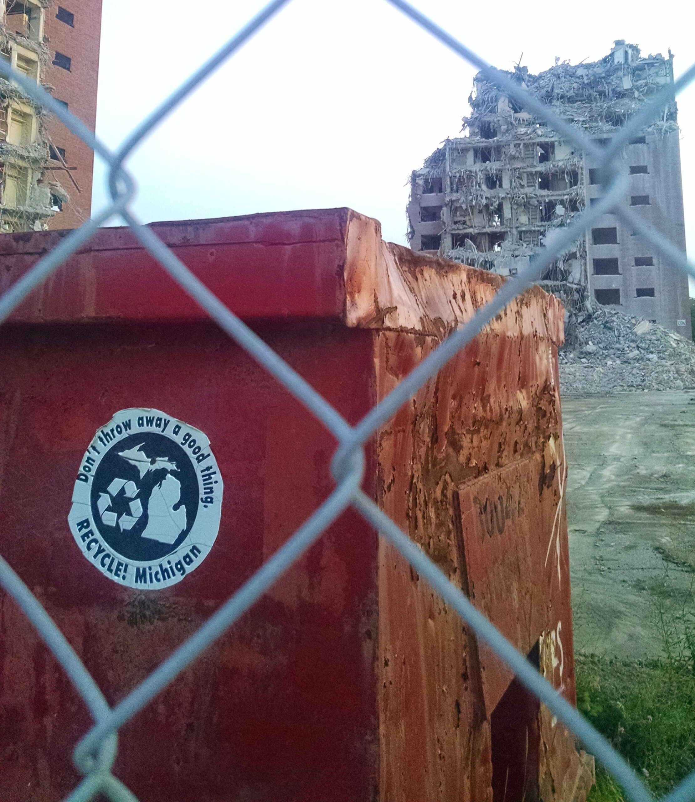 Scrap metal recycling container in front of Detroit’s former Brewster-Douglass Housing Projects during their summer 2014 demolition. Image credit: Nick Caverly