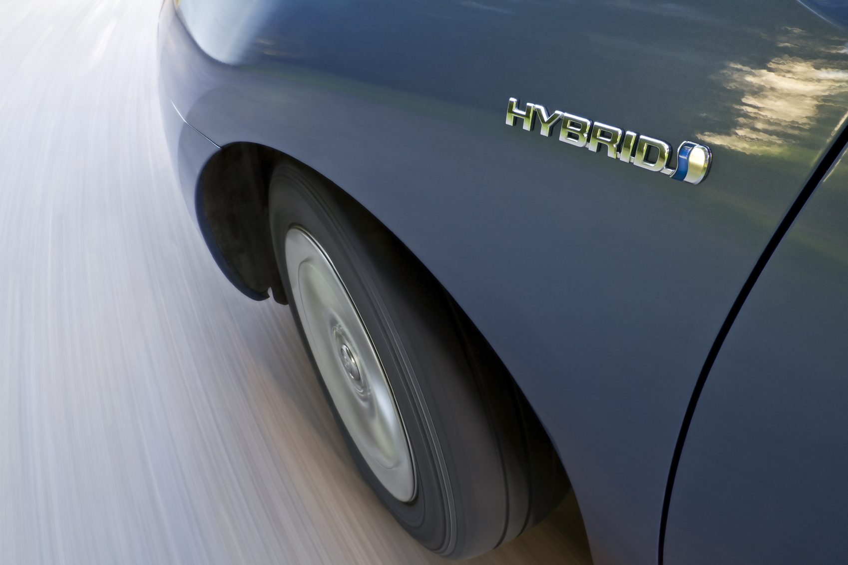 Hybrid emblem on a moving car. (stock image)
