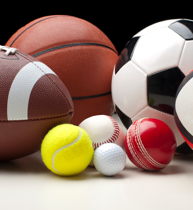 A football, basketball, tennis ball, golf ball, soccer ball, and rugby ball sitting on a table. (stock image)