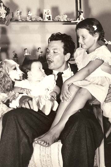 This 1945 image features the young father with his two daughters. Chris Welles Feder (right) was the artist's first child from his marriage to Virginia Nicolson. The infant in his arms, Rebecca Welles Manning, was born of his brief, passionate, and stormy union with the actress Rita Hayworth. (Image courtesy of the Special Collections Library at the University of Michigan.)