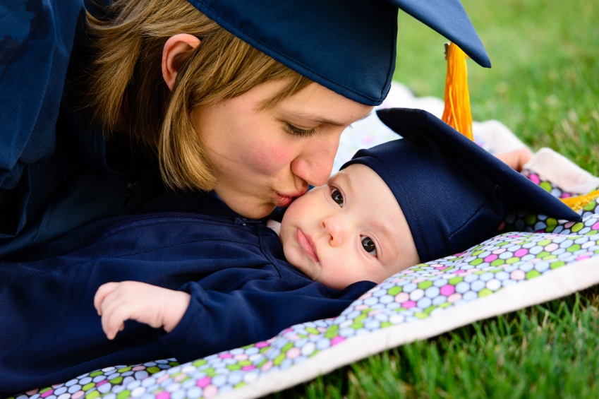 Mother and baby wearing graduation cap and gown. (stock image)