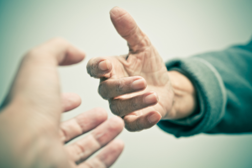Hands reaching for help. (stock image)