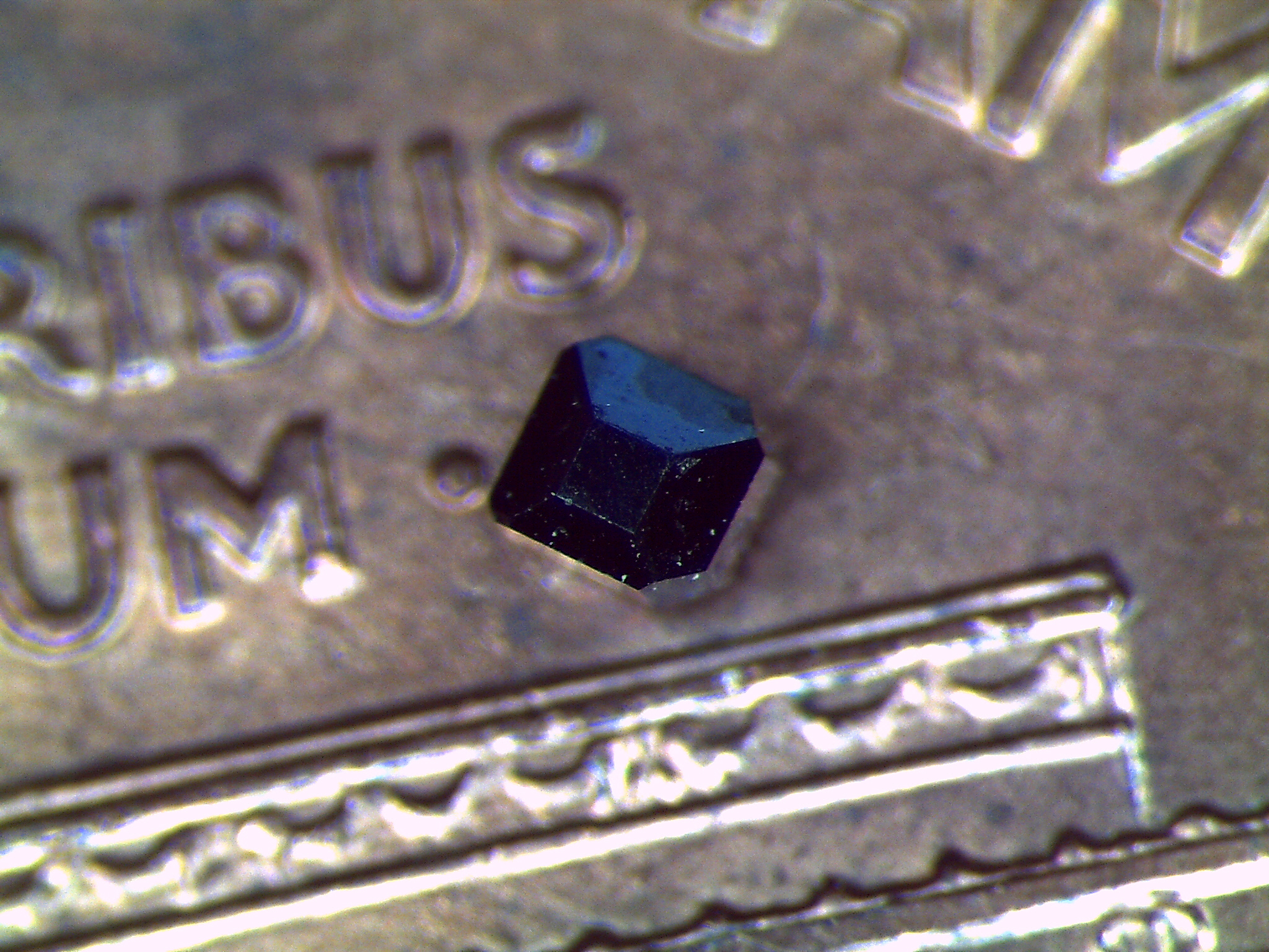 Samarium hexaboride, abbreviated SmB6, is a compound made of the metal samarium and the rare metalloid boron. University of Michigan researchers have confirmed its unusual electrical properties and shown how it could advance the development of next-generation transistors for quantum computers. A crystal of it sets on a penny. Image credit: Gang Li