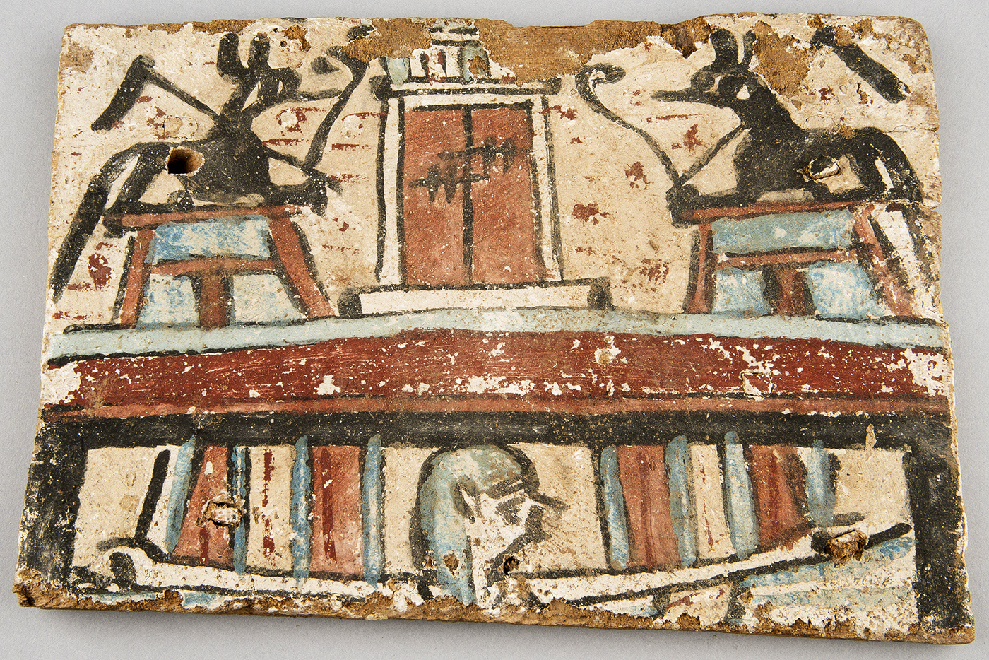 Painted wooden panel from a coffin showing two jackals representing the Egyptian gods Anubis and Wepwawet, Ptolemaic Period (332–30 BC), KM 88725. Image credit: Randal Stegmeyer, Kelsey Museum of Archaeology