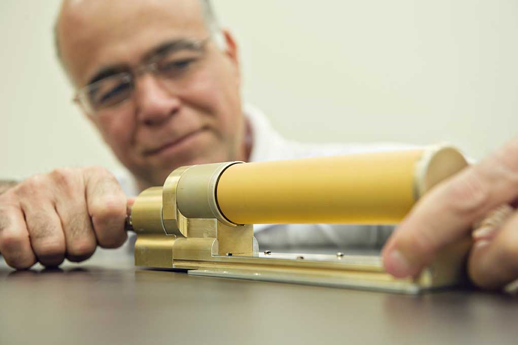 Professor Nilton Renno displays the Charge Tracker, a sensor that uses technology he developed to identify stray voltage from a distance of more than 10 feet. Image credit: Leisa Thompson