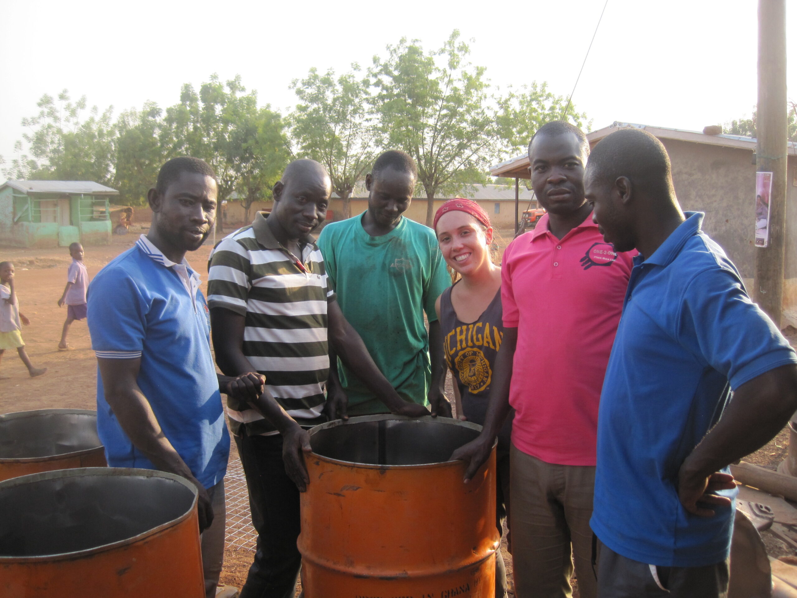 U-M alumna and Peace Corps volunteer Genevieve James gathers with teachers at an incinerator they built for the primary school in her community in northern Ghana. Image courtesy: Peace Corps