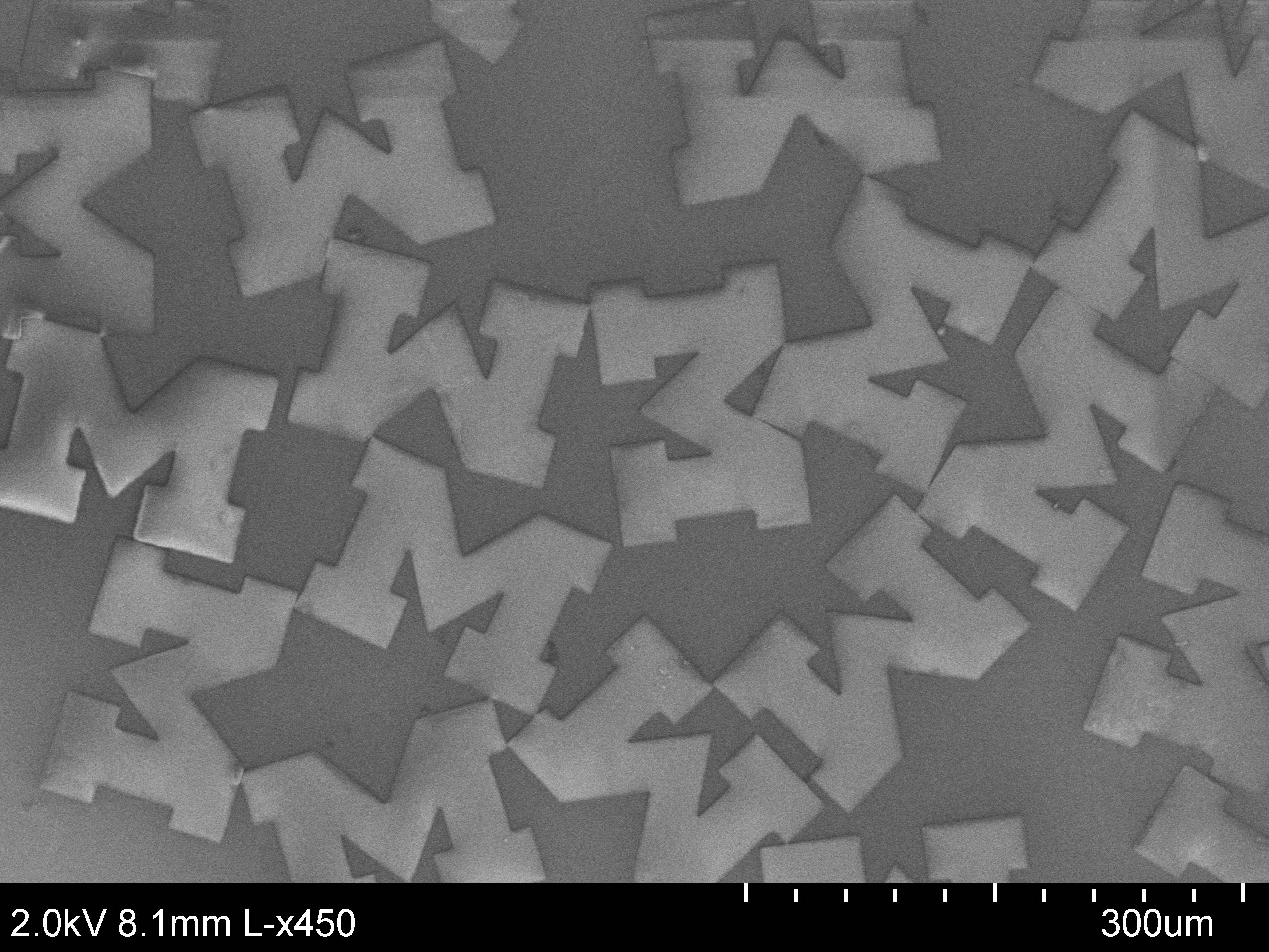 Three-layer Block M nanoparticles under an electron microscope. At 115- by 160 microns and 3 microns thick, the mock U-Michigan logos are each about the size of a grain of sand. Image courtesy Sai Pradeep Reddy Kobaku