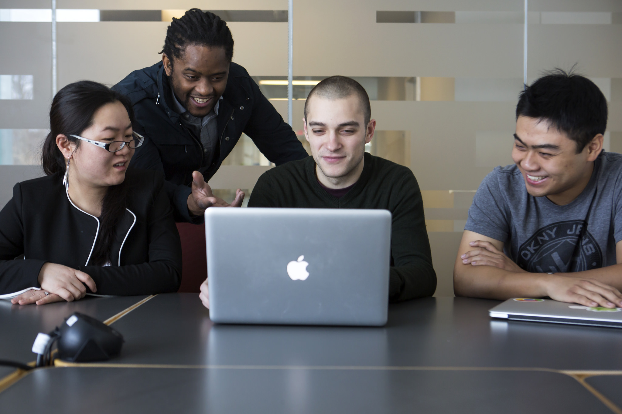 Lingjia Tang and Jason Mars, EECS Professors, review the group's program, Sirius, with Johann Hauswald and Yiping Kang, CSE Graduate Students. Image credit: Joseph Xu, Michigan Engineering, Communications & Marketing