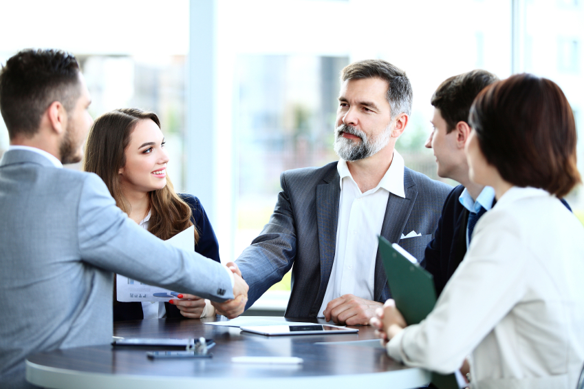 Business people shaking hands, finishing up a meeting. (stock image)