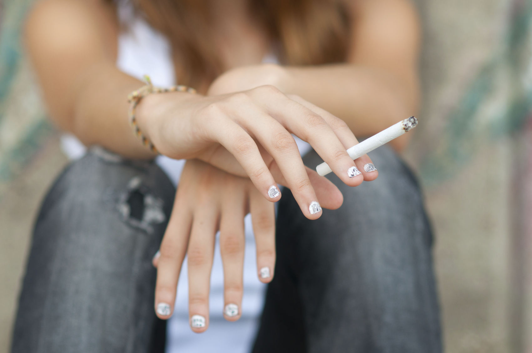  Teenage hands holding cigarette. (stock image)
