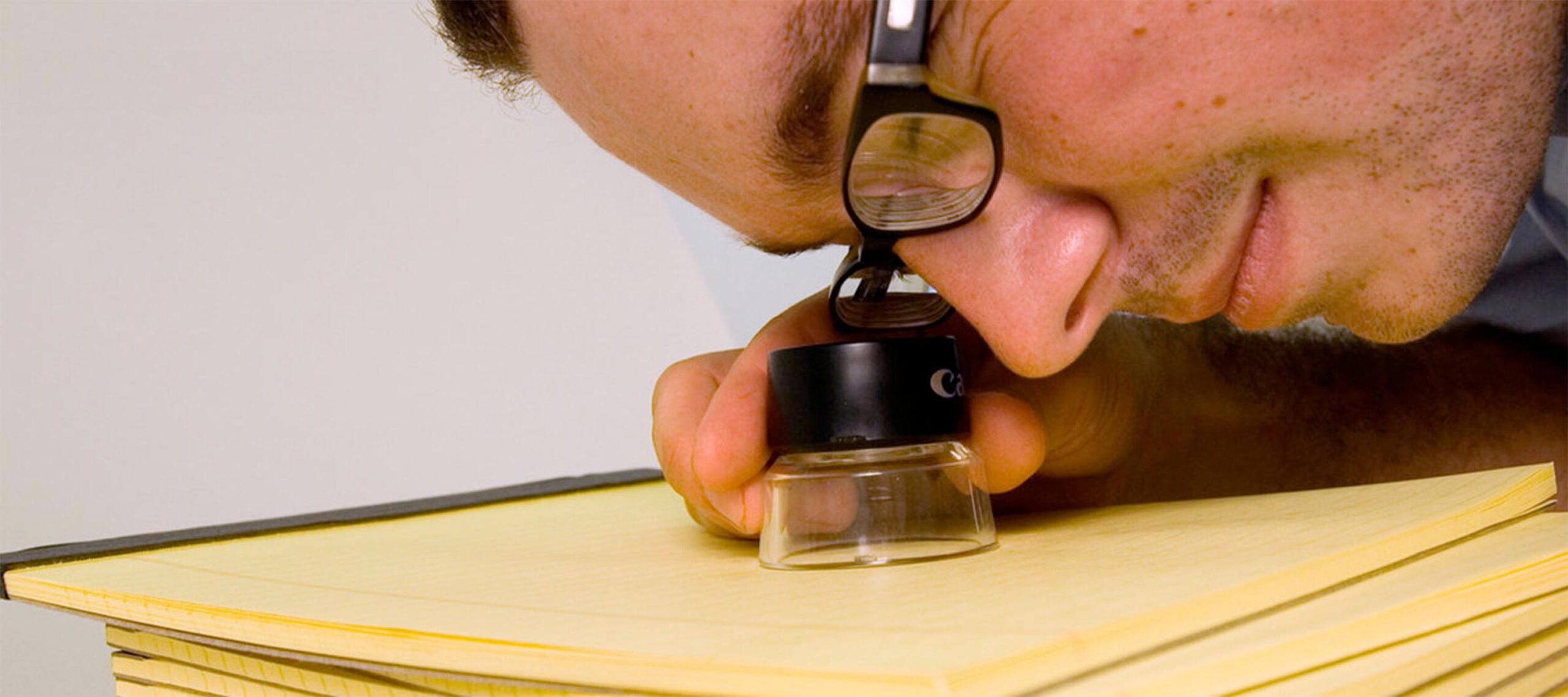 Viewing the micro-printed text through a loupe. Image courtesy: Matt Kenyon