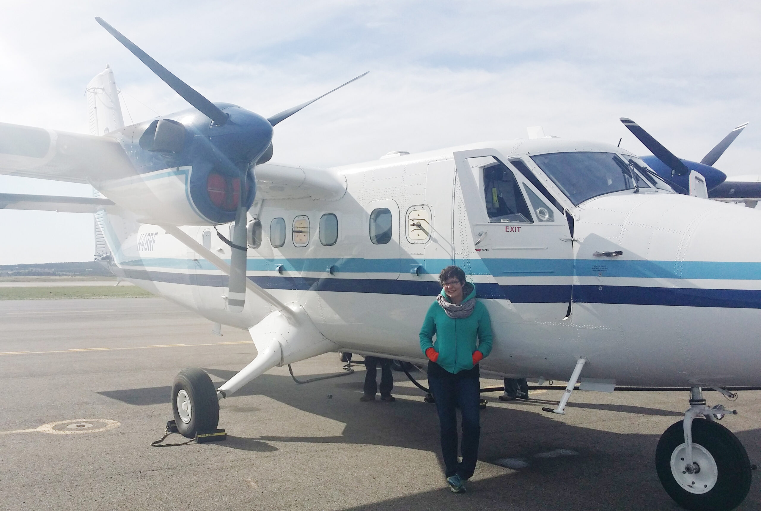 Mackenzie Smith, a postdoctoral researcher at Michigan Engineering, stands by the Twin Otter aircraft she is riding in to measure atmospheric methane over the Four Corners region. Image credit: Jake Blaauboer