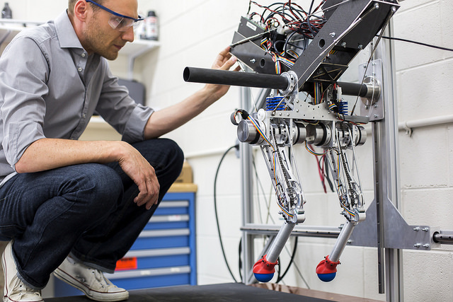 David Remy, ME Professor, works in the Robotics and Motion Laboratory (RAMLab) in the GG Brown Building, testing the research group's new robot, Ramone. Image credit: Joseph Xu