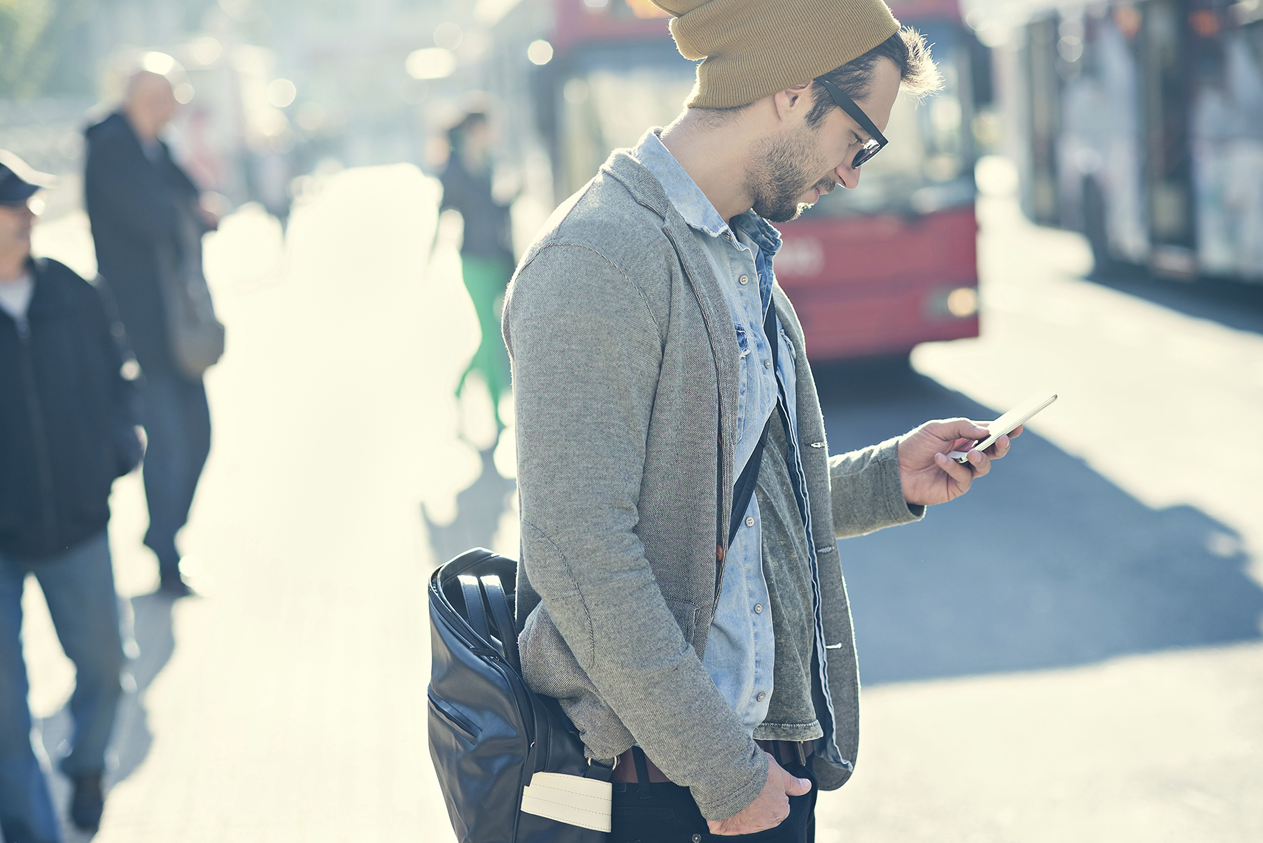 A man texting on his cell phone while stepping into the street. (stock image)