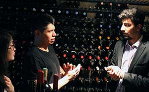 Students receive impromptu lecture in wine cellar.