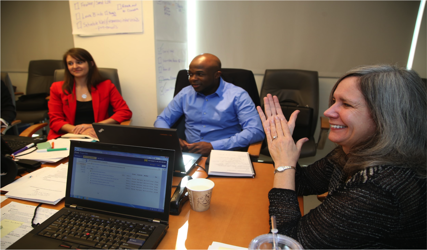MBAs meet with one of their faculty advisors, Paula Caproni, at Miami Dolphins headquarters. Pictured students are Alexa Likens and C.J. Azubuine. They’re working on a Multidisciplinary Action Project, or MAP. The team of six designed a comprehensive learning and development program for the NFL team. Image credit: Angel Valentin