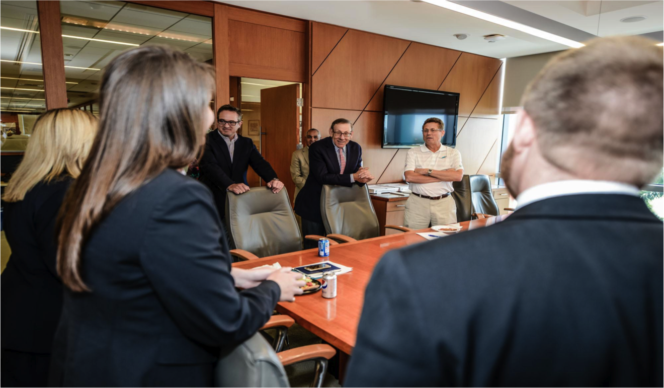 MBA students meet with Miami Dolphins executives Tom Garfinkel, president and CEO, Stephen M. Ross, chairman, and Dan Caspersen, senior vice president of human resources, during their project this spring to create Miami Dolphins University for the NFL team. Image credit: Angel Valentin