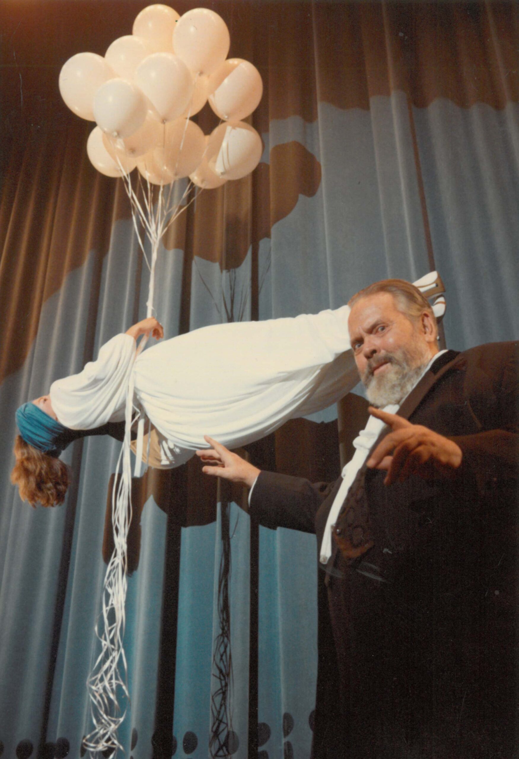 Photograph by Oja Kodar (?): One of several prints of Welles performing a levitation trick, cropped and used for the cover of a special issue of Paris Vogue(1982/1983). Courtesy the University of Michigan Library (Special Collections Library)