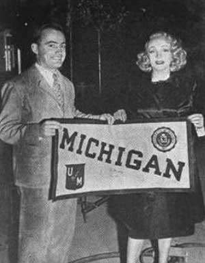 Dawson and Dietrich with Michigan banner.