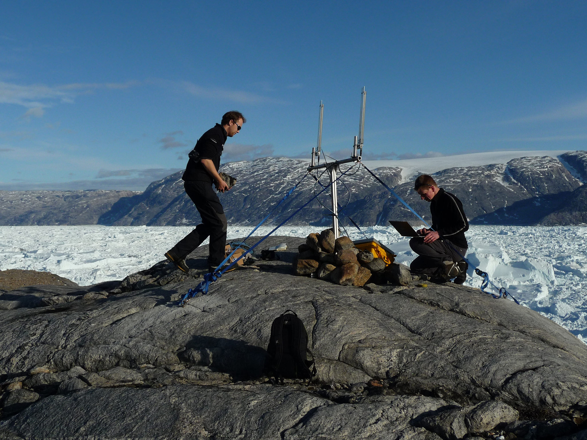 Researchers prepare the GPS network receiving station on the north side of Helheim Glacier. Image credit: Stuart Edwards, Newcastle University