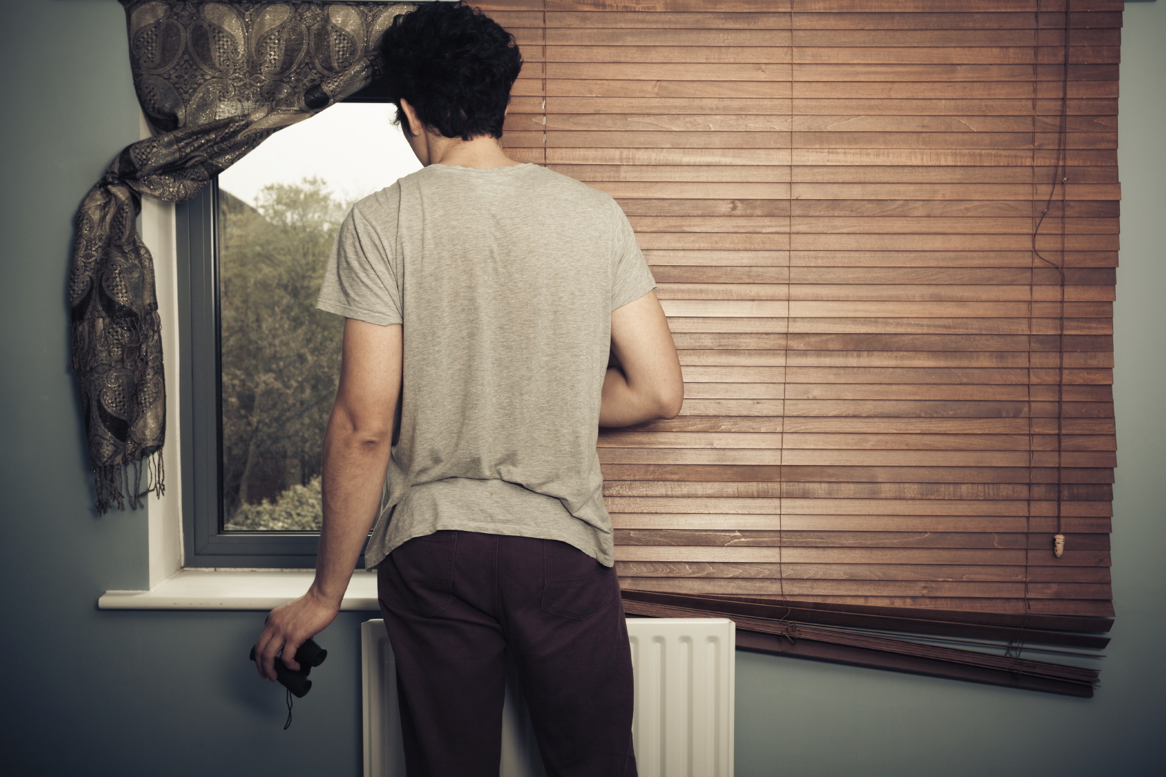 Nosy neighbour with binoculars. (stock image)